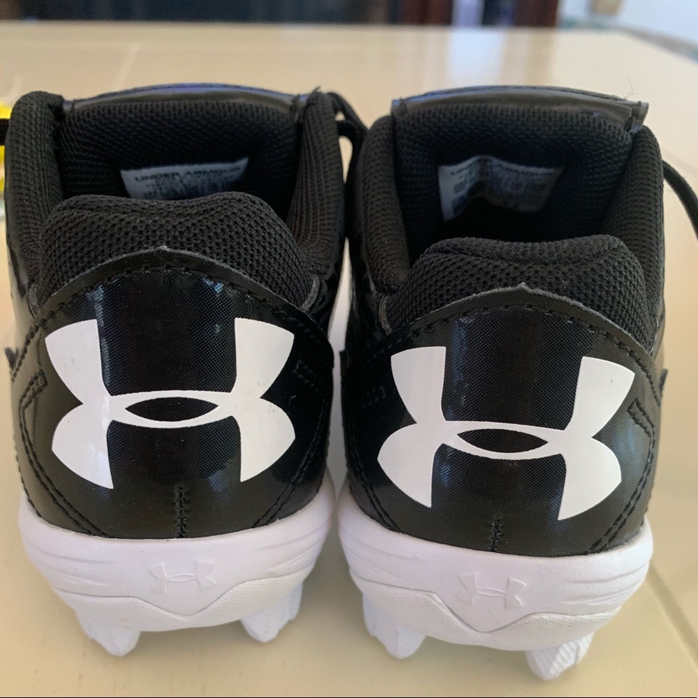 Little boys under armour cleats .